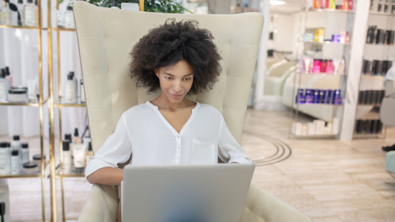 Beauty salon owner checking her numbers on a laptop